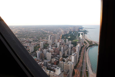 Aerial view of city buildings against clear sky