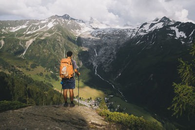 Man hiker standing on a hilltop in the french alps, le tour, france