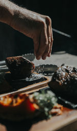 Cropped hand of person preparing food