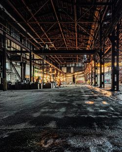Empty road amidst buildings in city