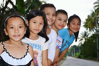 Portrait of smiling friends in park