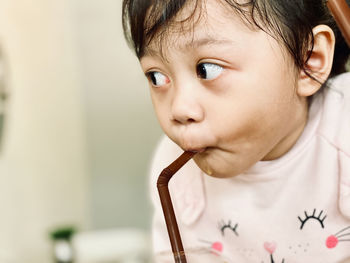 Close-up portrait of cute boy looking away