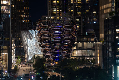 Illuminated modern buildings in city at night