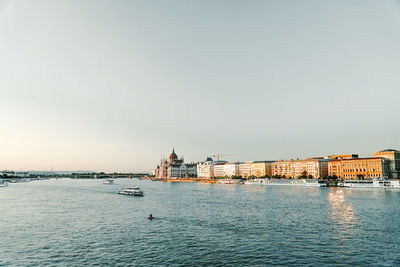 View of buildings in city against clear sky