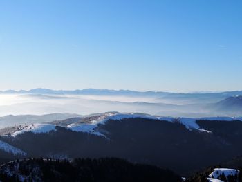 Scenic view of mountains against clear blue sky