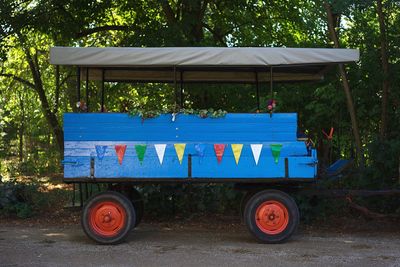 View of blue cart against trees