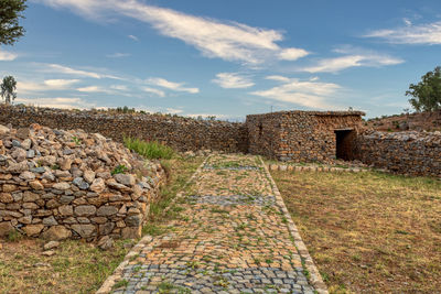 Stone wall against sky