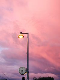 Low angle view of illuminated street light against sky at sunset