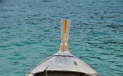 Boat anchored on blue rippled water