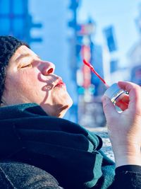 Close-up of woman blowing on bubble wand