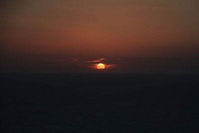 Scenic view of sea against orange sky