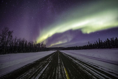 Road against sky at night during winter