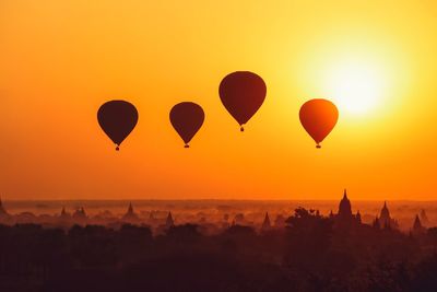 Silhouette of hot air ballons over bagan at sunrise in misty morning, myanmar 