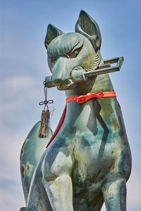 Low angle view of statue against sky