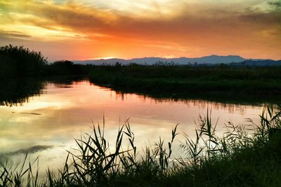 Scenic view of lake at sunset