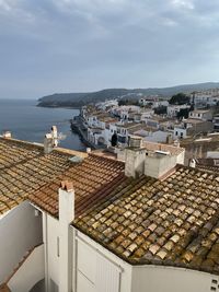 High angle view of townscape by sea against sky