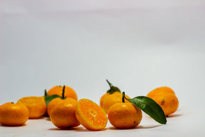 Close-up of orange fruits against white background