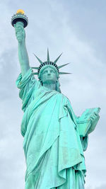 Low angle view of statue against sky