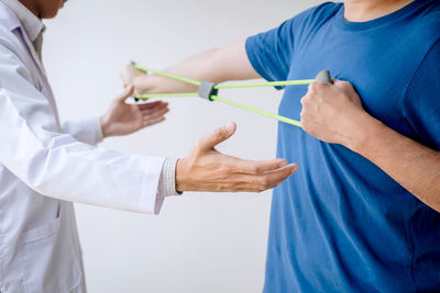 Midsection of couple holding hands