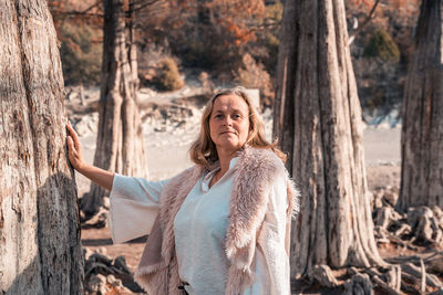 Portrait of smiling young woman in forest