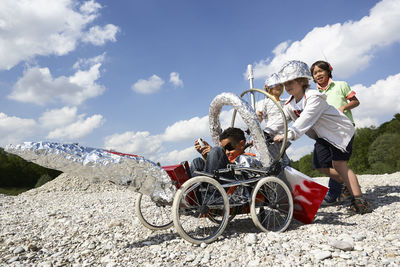 Four boys with self-made rocket playing moon landing