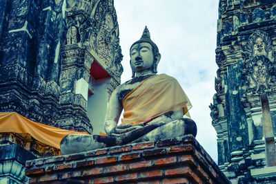 Low angle view of statue against temple building