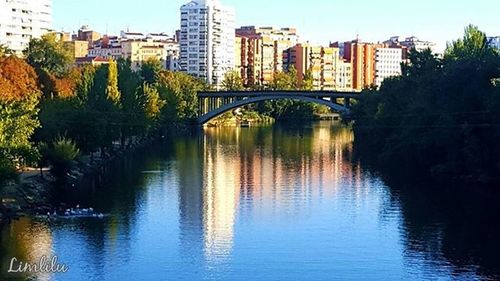 Bridge over river with buildings in background