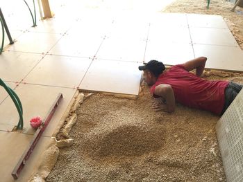 High angle view of man lying on floor