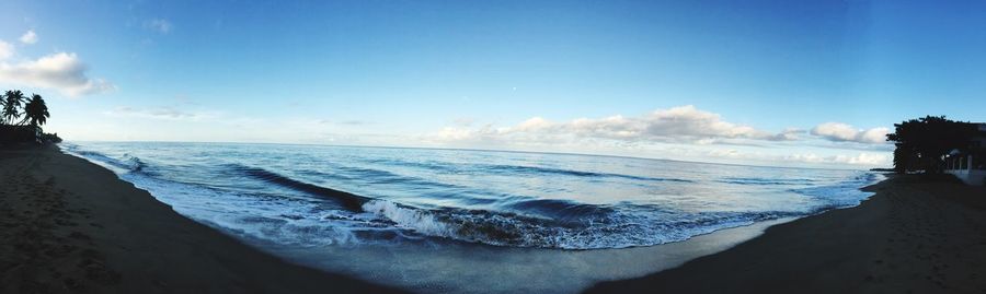 Panoramic view of sea against blue sky