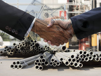 Digital composite image of businesspeople and paper currency