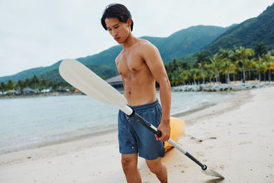 Rear view of man standing on beach