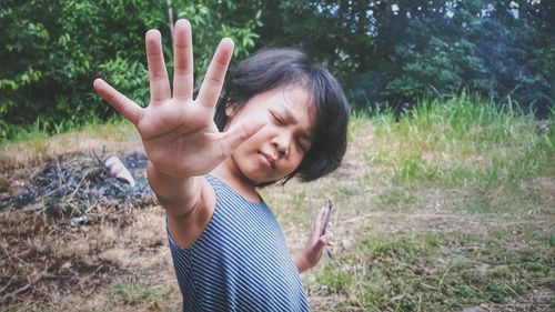 Portrait of child holding out hand