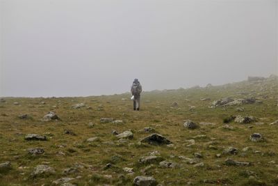 Man standing on field against clear sky