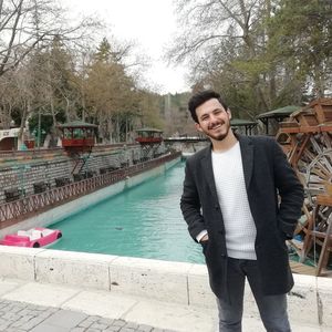 Portrait of young man standing in swimming pool