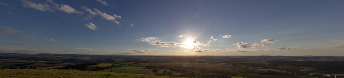 Scenic view of field against sky at sunset