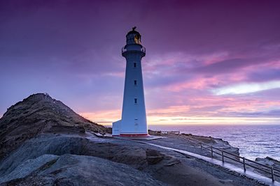 Lighthouse against sky during sunset