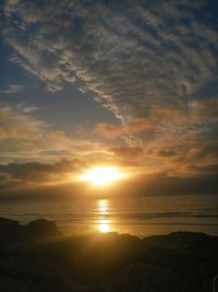 Scenic view of sea against sunset sky