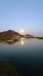 Scenic view of lake against clear blue sky