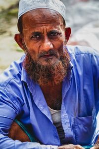 Portrait of man sitting outdoors