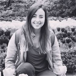 Portrait of smiling young woman sitting outdoors