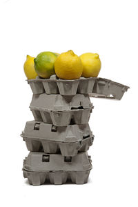 Close-up of oranges on stack against white background