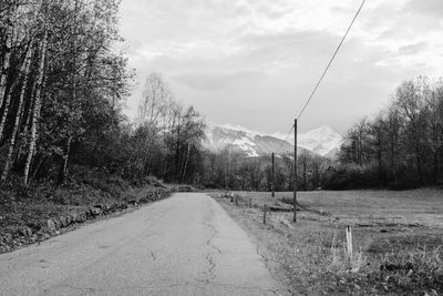 Road amidst trees against sky