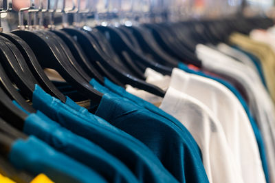 Close-up of clothes on rack at store