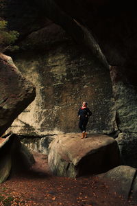 Rear view of woman standing on rock