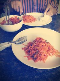 Close-up of hand holding food on table