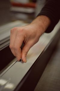 Close-up of hand holding table