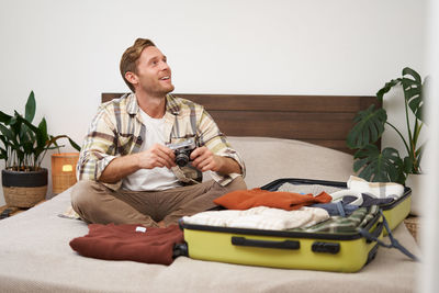 Portrait of senior man sitting on sofa at home