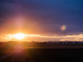 Scenic view of field against sky during sunset