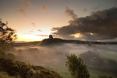 Scenic view of landscape against cloudy sky