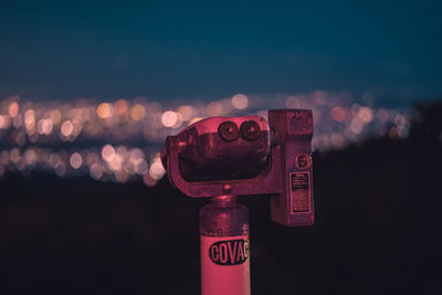 Close-up of telephone booth against illuminated sky during sunset